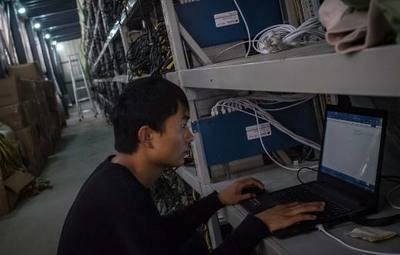 A mining farm with rows of mining machines.